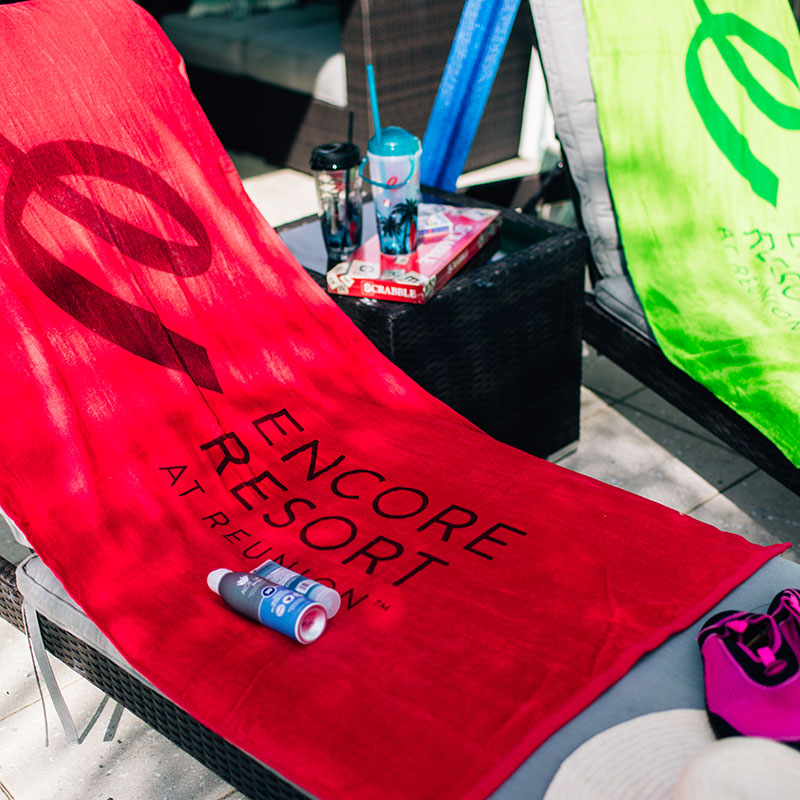 Encore Resort towel on a beach chair.