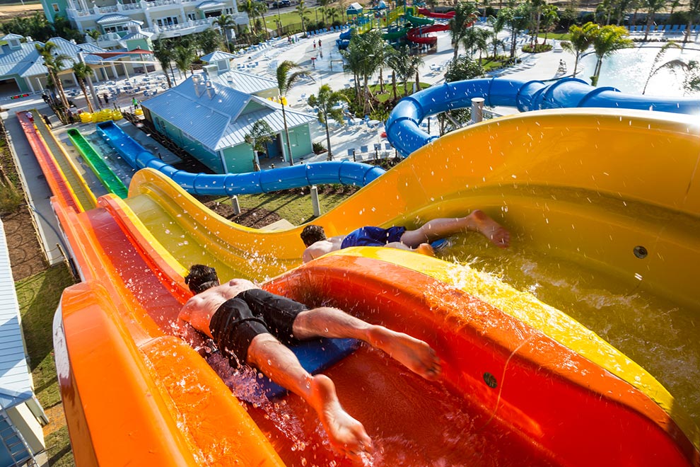 Two people slide down the WaveRacer water slide at Encore Resort at Reunion’s water park.