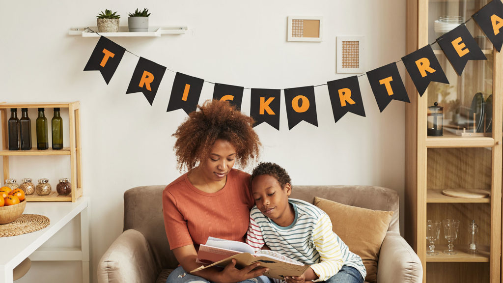 Mother and her son read a Halloween story.