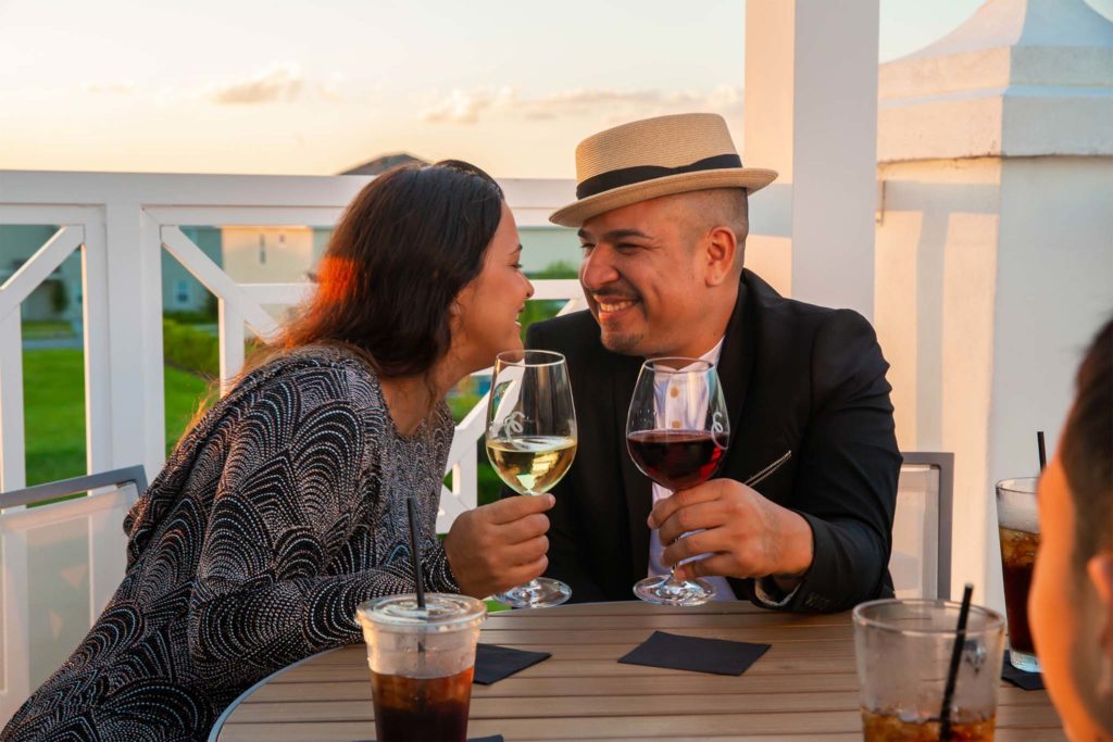 Couple smiling as they toast with wine glasses during a romantic Valentine’s Day dinner at the Encore Resort at Reunion Clubhouse.