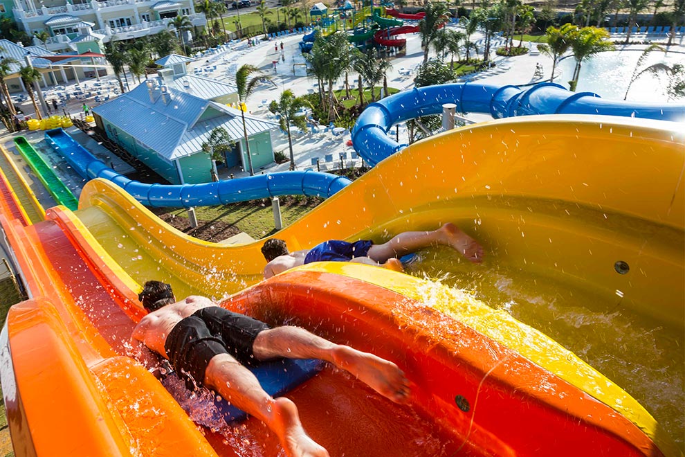Two kids slide on mats down the Wave Racer water slide at the Encore Resort Water Park.