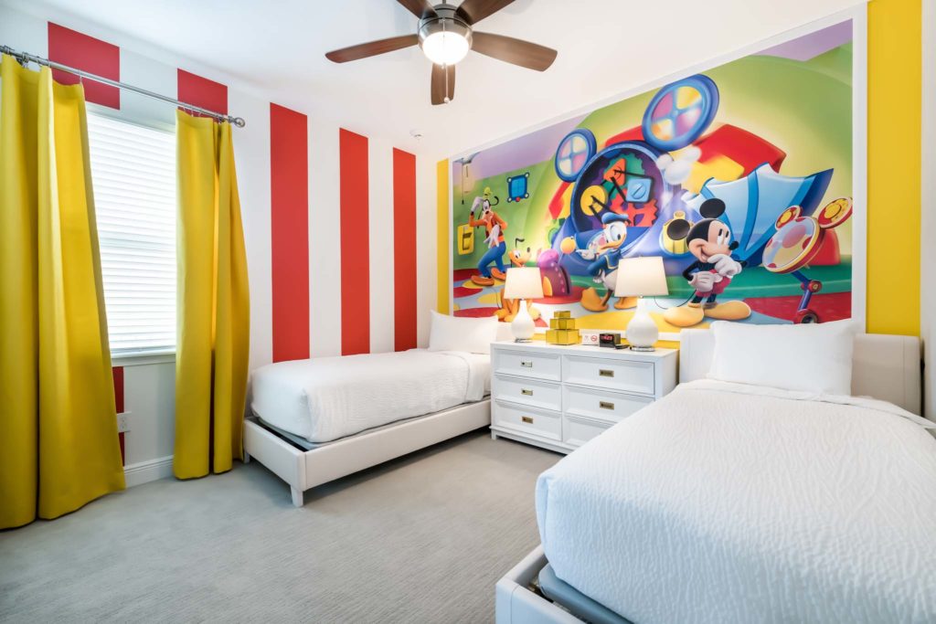 Disney-themed kids’ bedroom with a Mickey Mouse Clubhouse mural inside an Encore Resort at Reunion vacation home.
