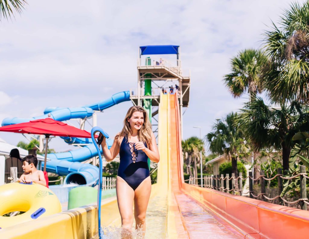 Woman laughs after riding a water slide at Encore Resort at Reunion’s water park.