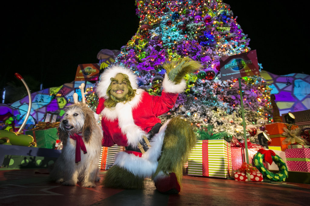 The Grinch in front of the Christmas tree at Universal Studios