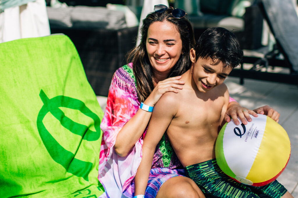 Mother and son on a lounge chair with a beach ball