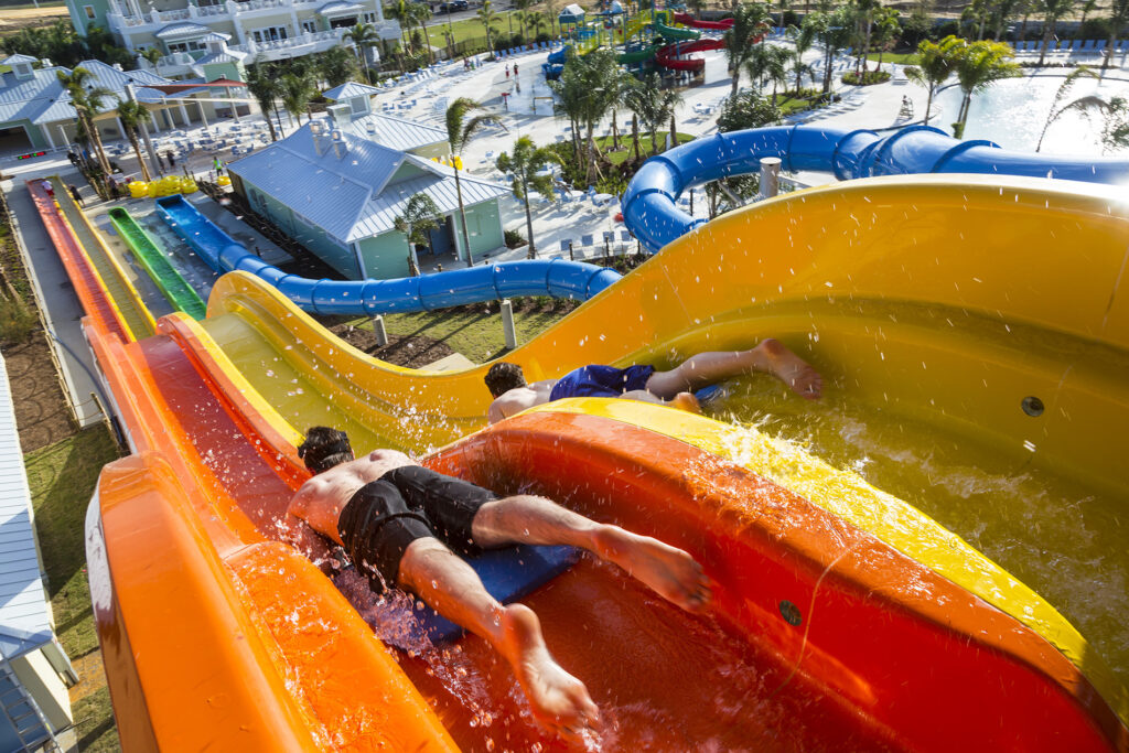 Father and son racing down water slide