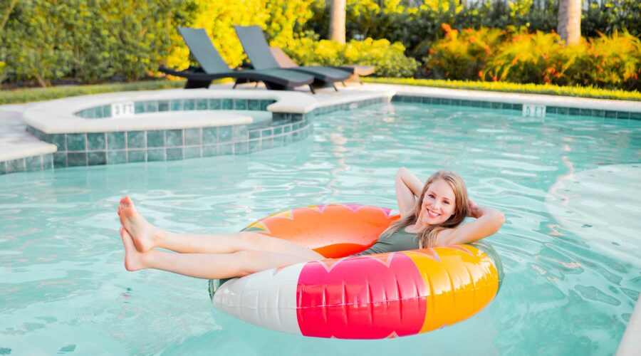 Young woman in a tube while floating in a pool