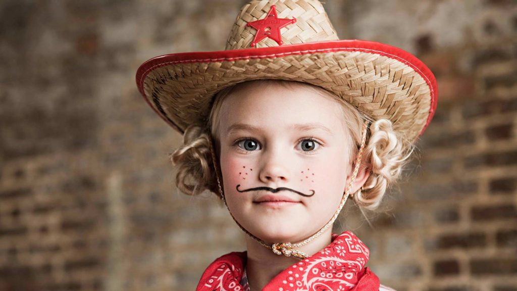 Young girl in a cowgirl Halloween Costume