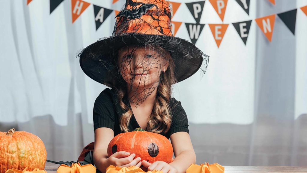 Young girl dressed as a witch