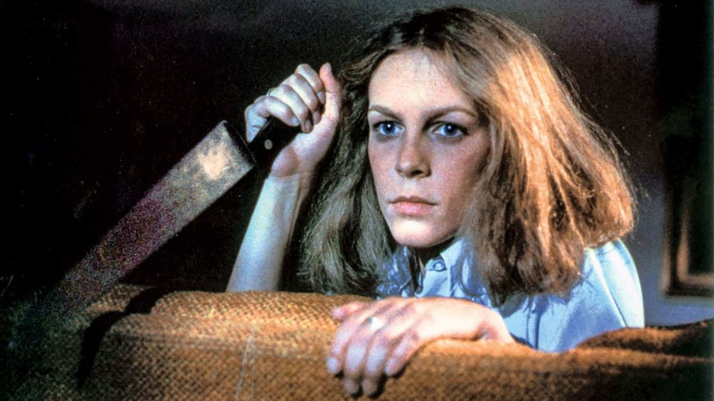 Jamie Lee Curtis holding a knife in the 1978 Halloween movie