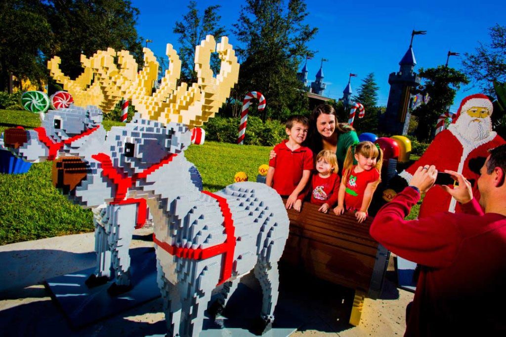Family taking a photo with Lego Santa and reindeer at Legoland Orlando