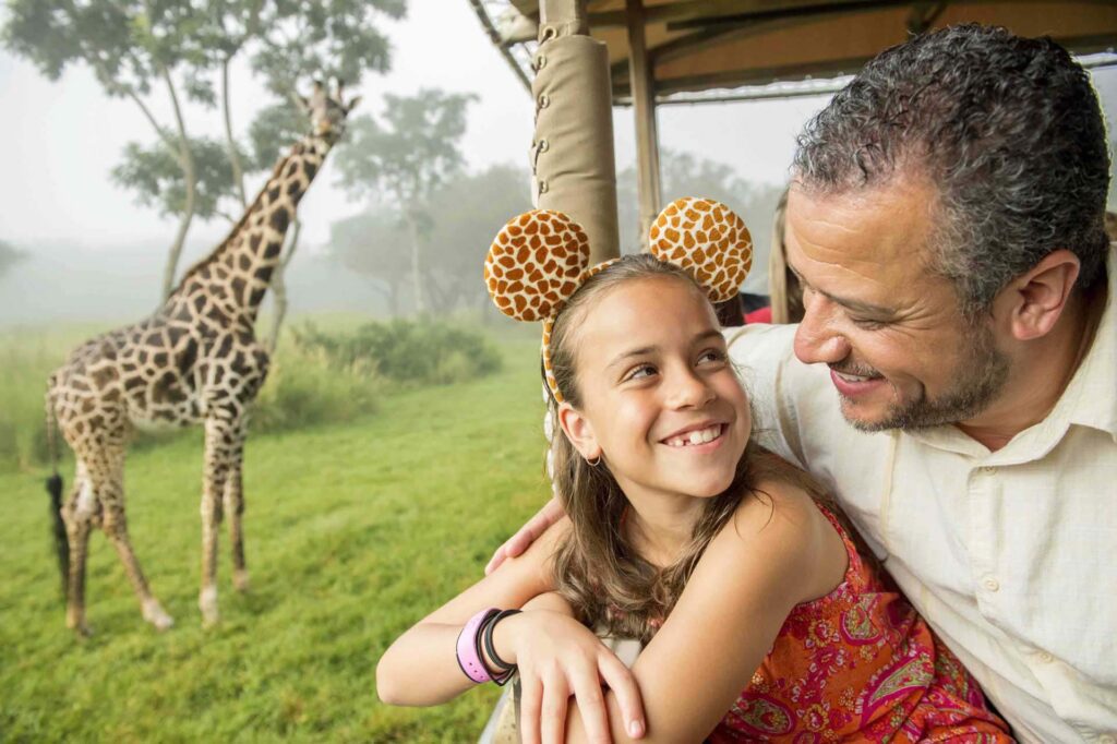 Happy father and daughter riding on Kilimanjaro Safaris at Disney's Animal Kingdom