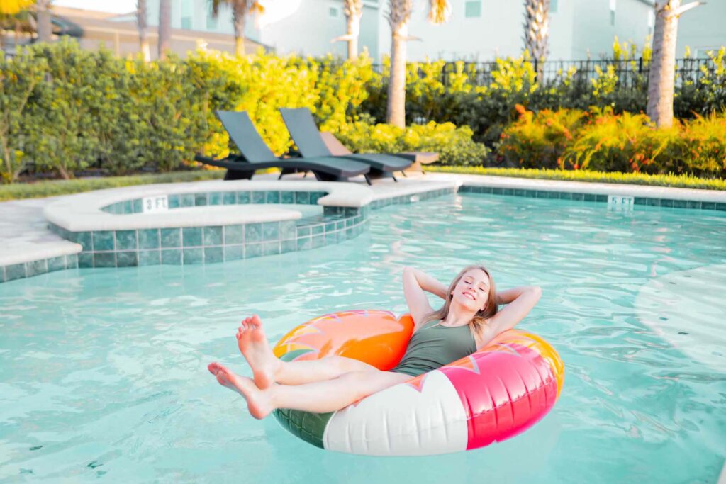 Woman resting in tube in her private Encore Resort home pool
